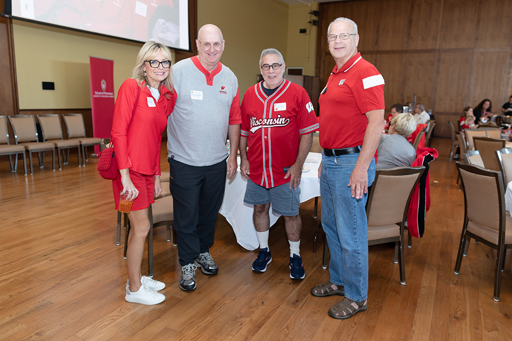 UW–Madison School of Pharmacy 2024 Alumni Tailgate and Watch Party Beth Martin, Gregory Weber, Elliot Rifzis, and another alum smile for a photo