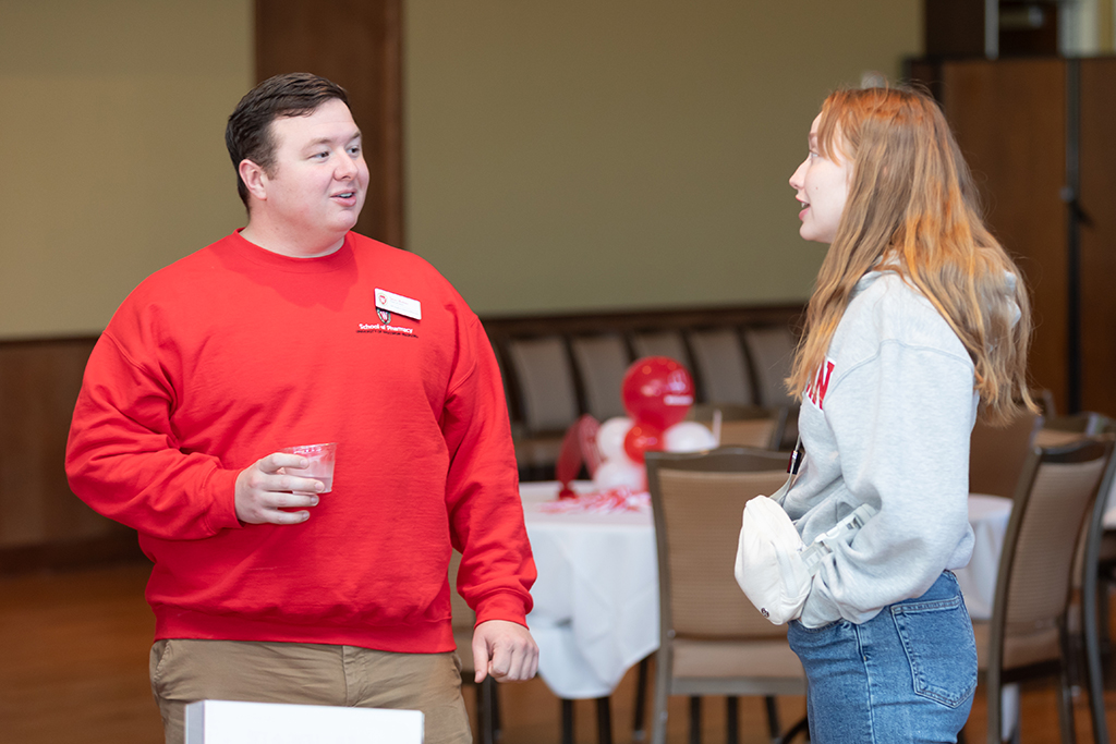 UW–Madison School of Pharmacy 2024 Alumni Tailgate and Watch Party Sean Baltes speaks with another student pharmacist
