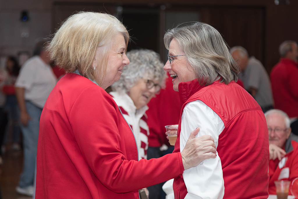 School of Pharmacy Alumni Tailgate Party 2023 Two alumni laughing together
