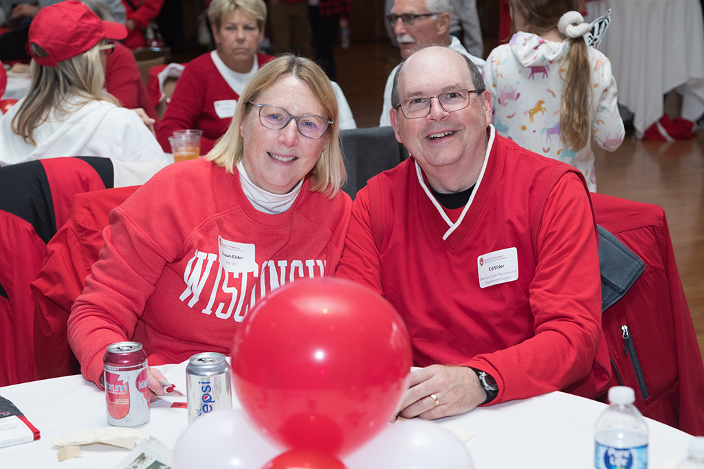 School of Pharmacy Alumni Tailgate Party 2023 Ed Elder with his wife sitting at table