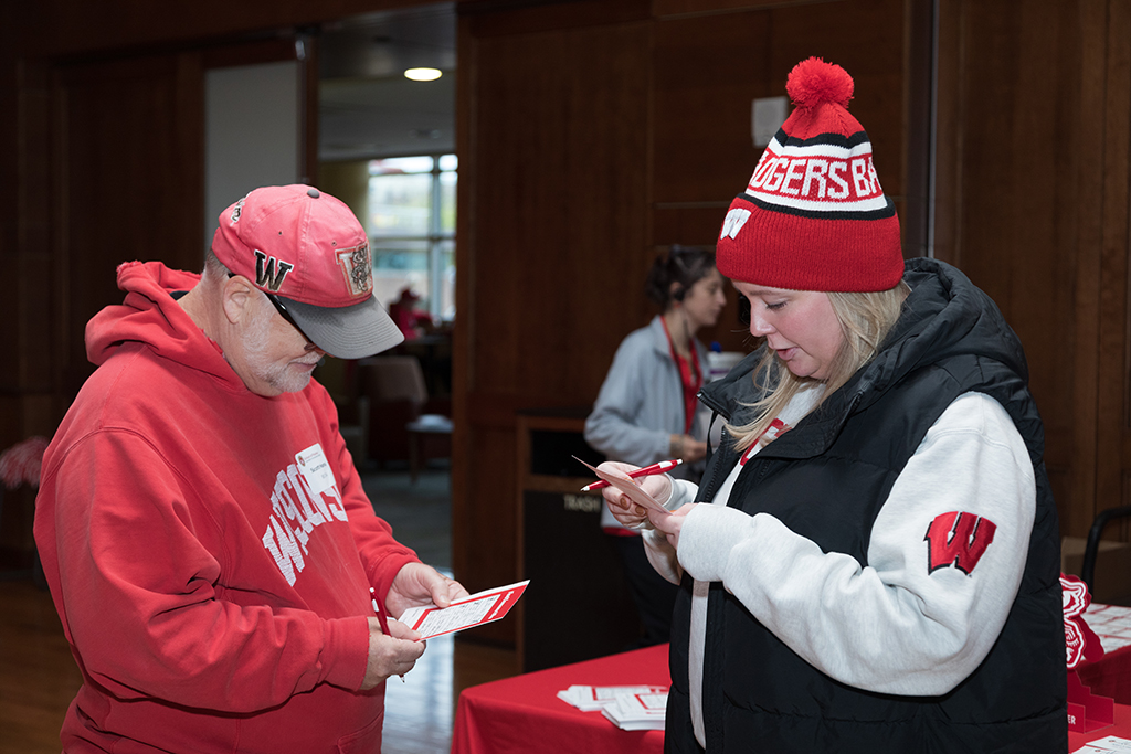 School of Pharmacy Alumni Tailgate Party 2023 Alumni working on their bingo cards