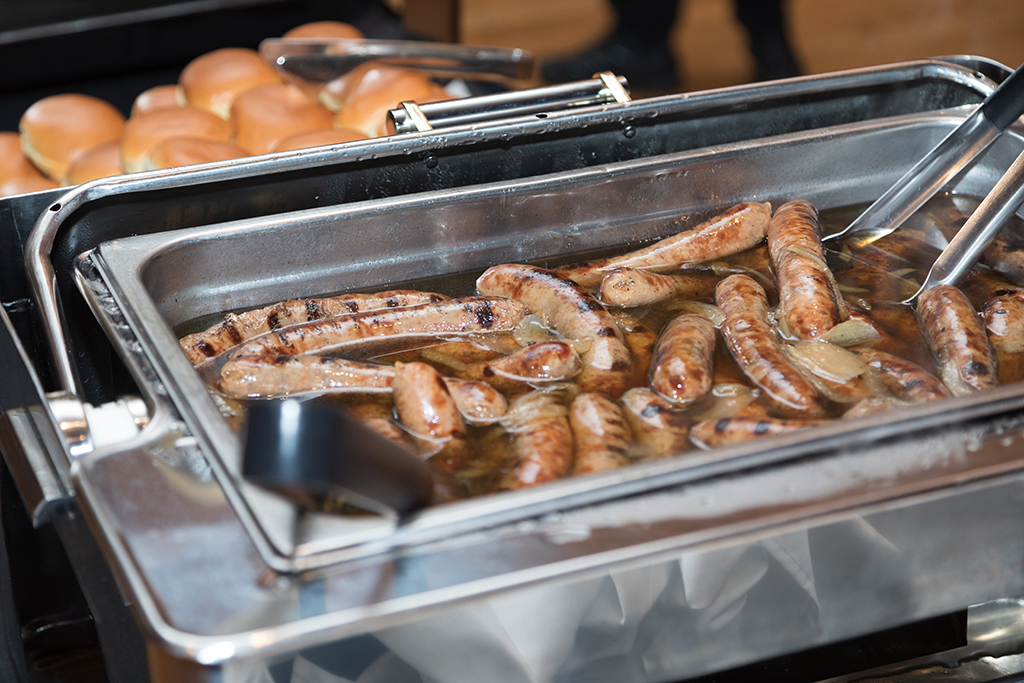 School of Pharmacy Alumni Tailgate Party 2023 Close up of brats sitting chafing dish