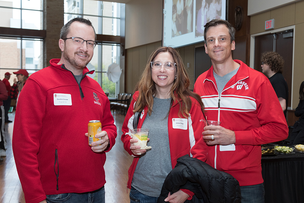 School of Pharmacy Alumni Tailgate Party 2023 Alumni holding drinks and smiling for the camera