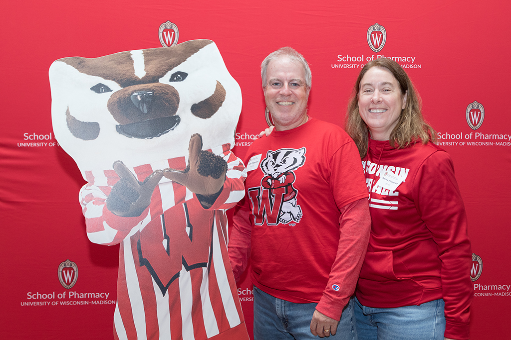 School of Pharmacy Alumni Tailgate Party 2023 Alumni pose with Bucky Badger cutout
