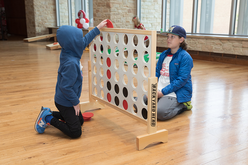 School of Pharmacy Alumni Tailgate Party 2023 Two kids playing large version of connect 4