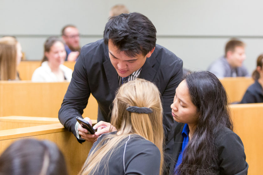 Students looking at information on phone