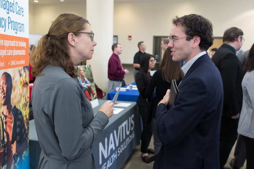 Student speaking to staff at Career development day