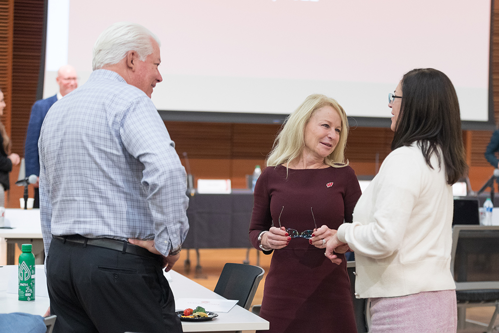 UW–Madison School of Pharmacy Board of Visitors Meeting 2022 Dan Luce and Nancy Gilbride speak with another female attendee.