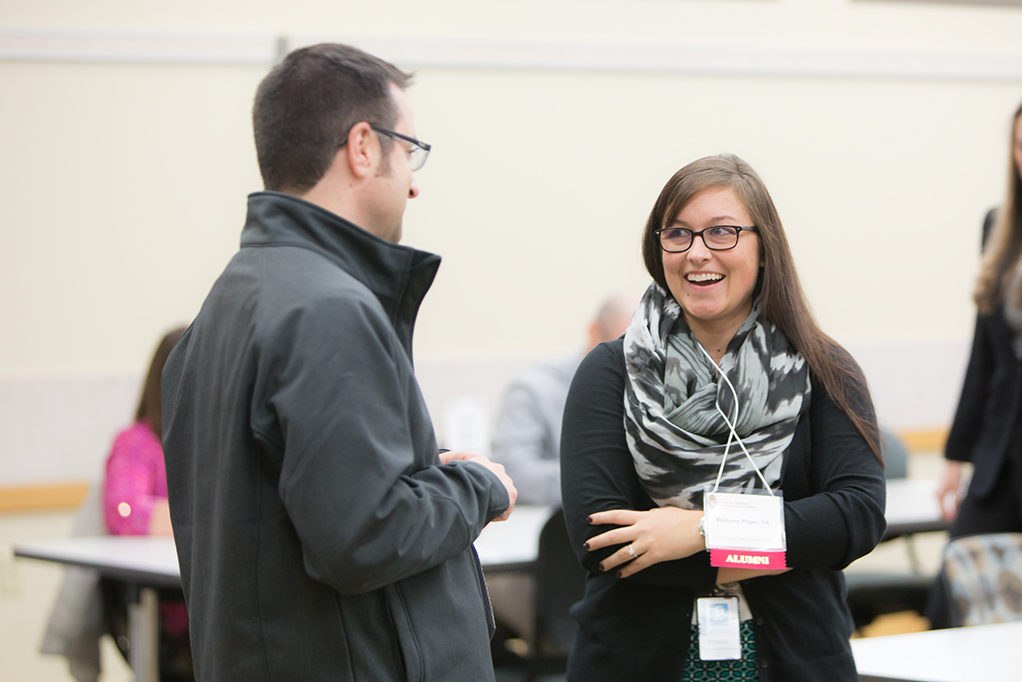 Two alumni catching up at the Roundtable Networking event to bring together current PharmD students and alumni.