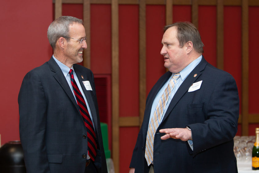 phar110819_102 Dean Steve Swanson and Dave Mott talking together at Citations of Merit dinner