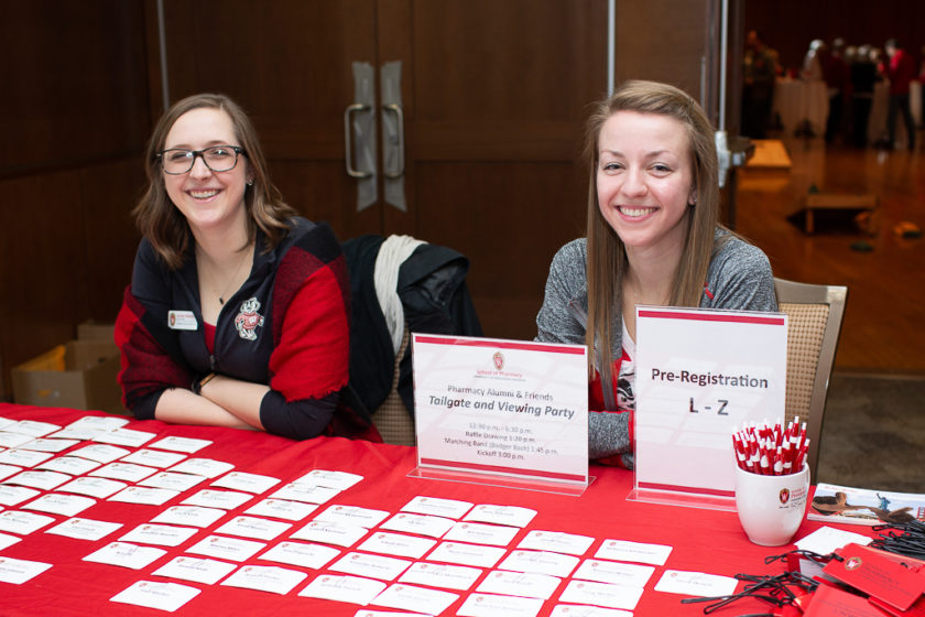 phar110919_001 Girls behind sitting check-in table for Alumni Tailgate and Viewing Party