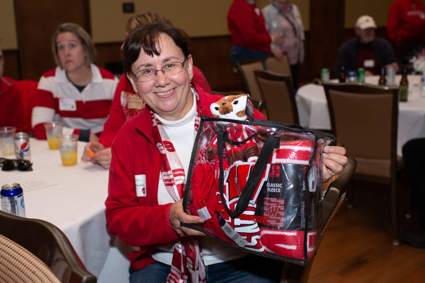 phar110919_074 Alumni at the 2019 Tailgate, woman holding bag of badger merch
