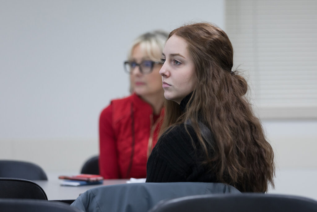 SoP Lecture: Cultivating Belonging in Pharmacy (December 1, 2023) A PharmD student watching a presentation during DiveRxsity Dialogues.