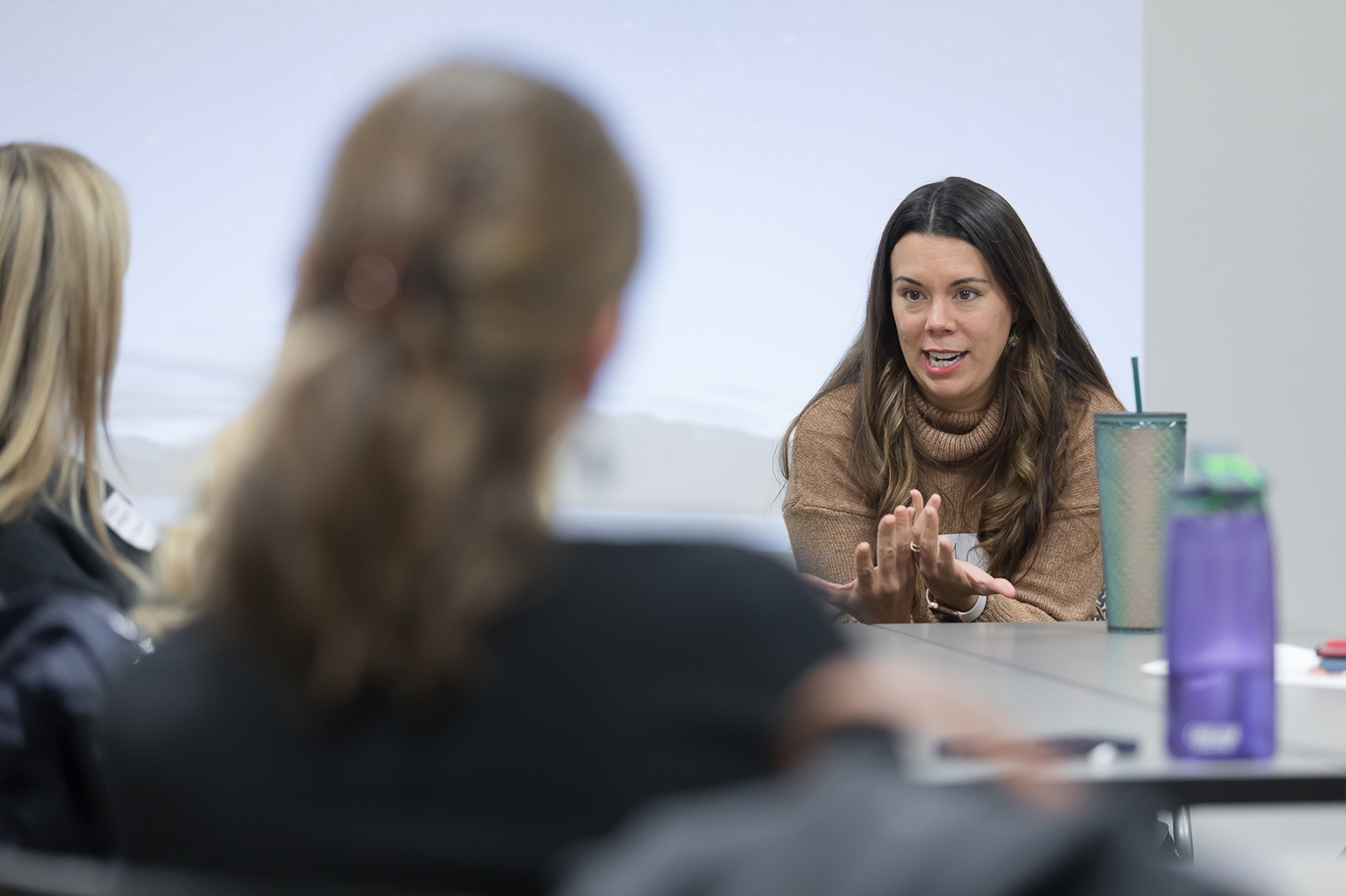 Amy Parins speaks at a table with students