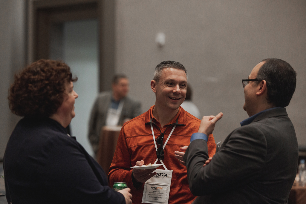 pharma0346_ Sarah Sorum and Nick Olson speak with another attendee