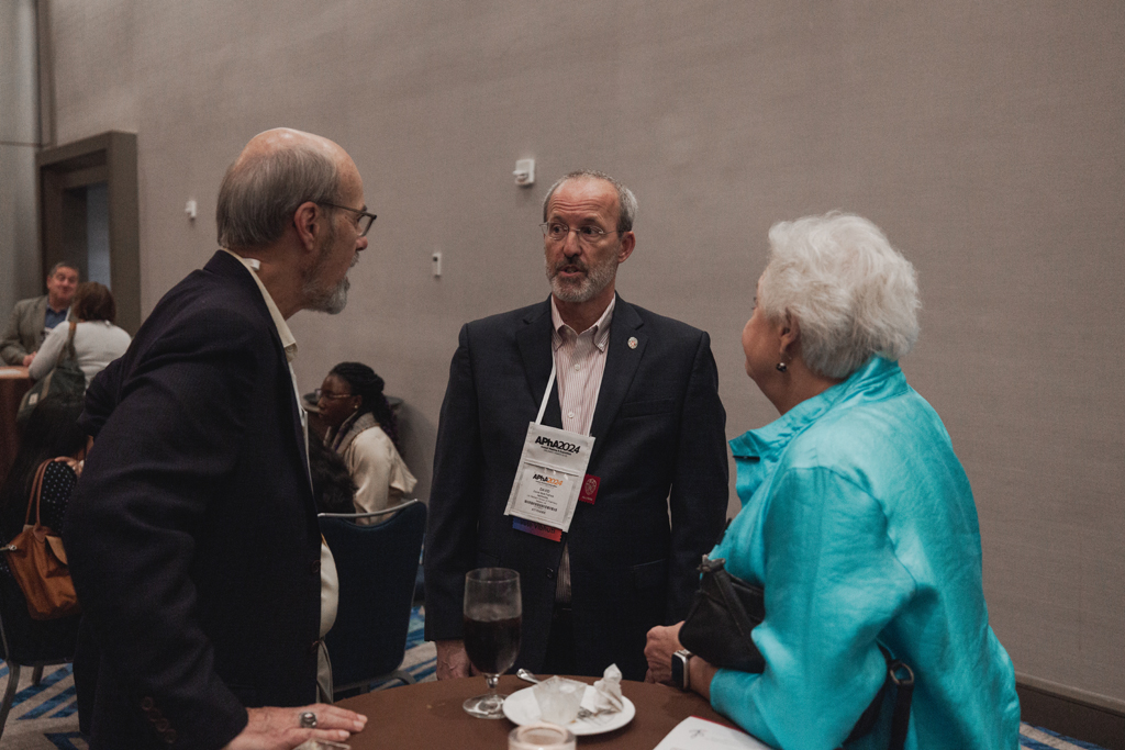 pharma0404_ Dave Mott speaks with two attendees