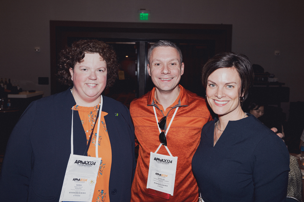 pharma0409_ Sarah Sorum, Nick Olson, and another attendee pose for a photo