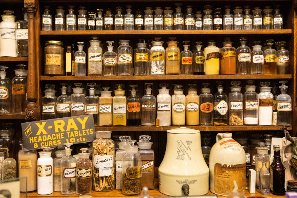 real-life-photographs-20 A variety of glass jars containing a range of items, labeled "cubebae," "poly cardam," "ammon chlor," and more.
