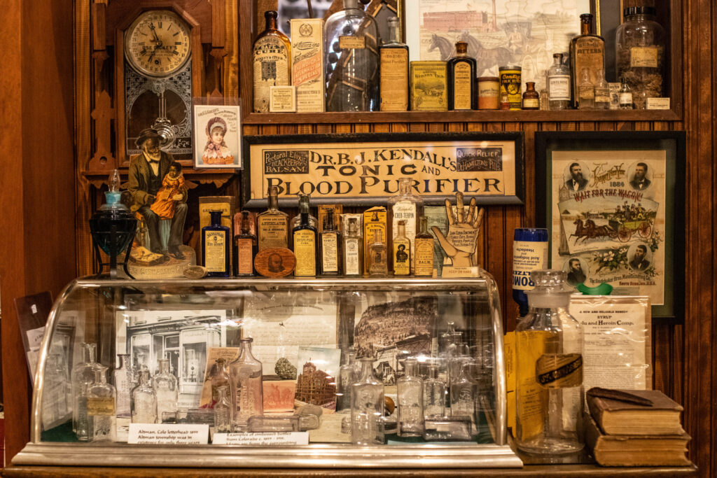 real-life-photographs-31 A display featuring many glass bottles and a sign that reads "Dr. B.J. Kendall's Tonic and Blood Purifier."