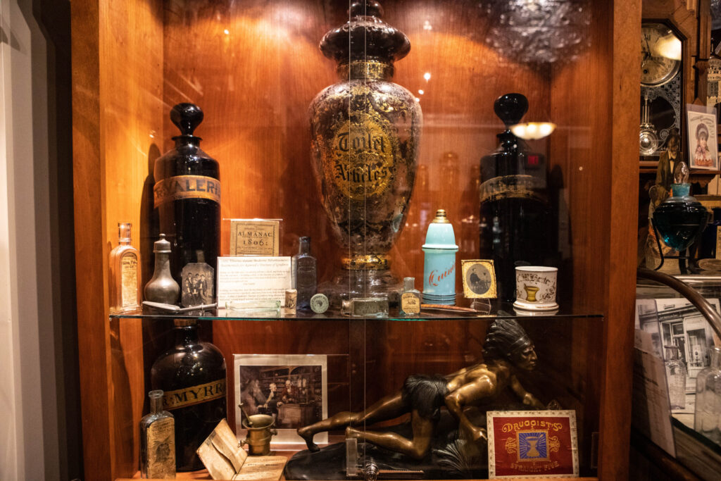 real-life-photographs-44 A glass cabinet filled with glass jars and urns.