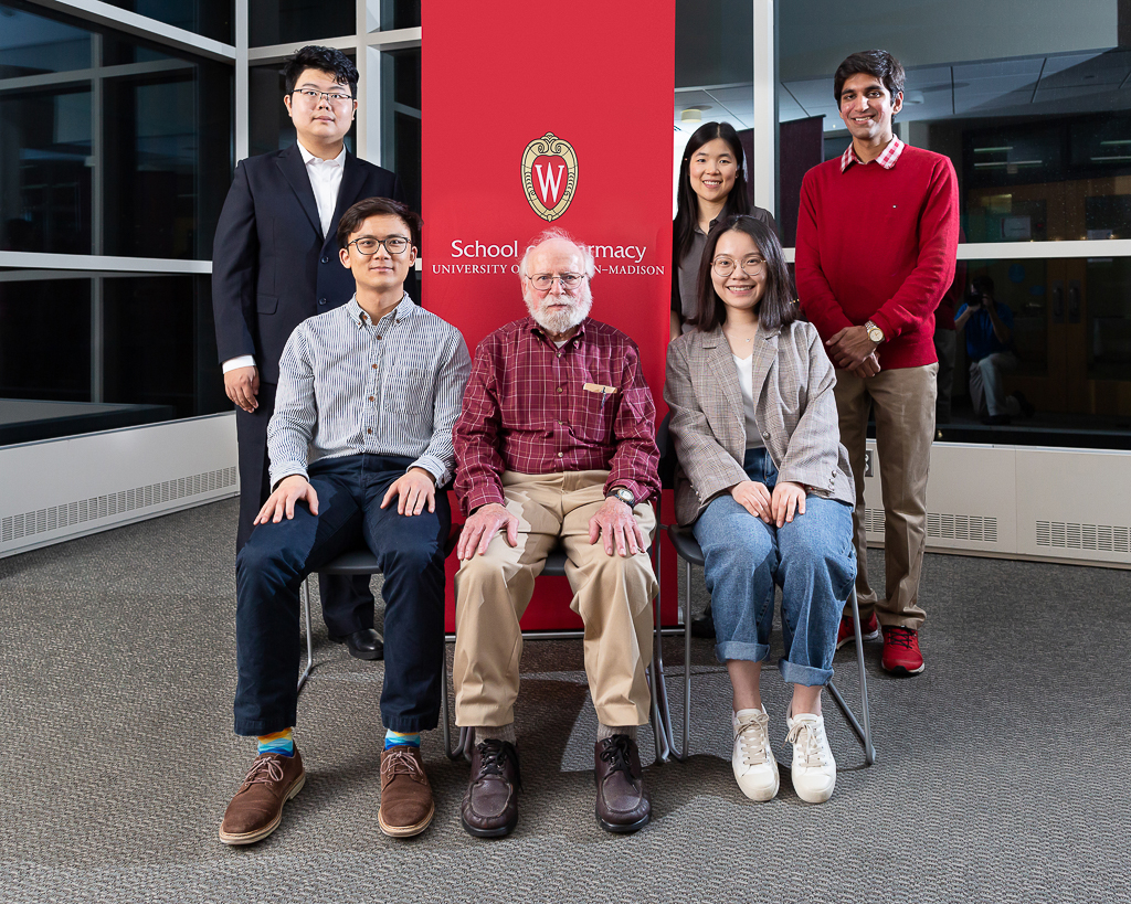 sop092719_003 Ken Connors with current and former recipients of his fellowship by School of Pharmacy banner
