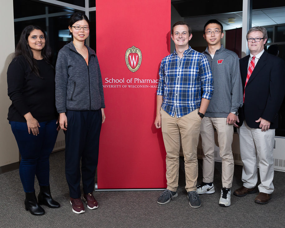 sop092719_004 Teaching assistant award-winners Tanvee Thakur, Niying Li, Connor Blankenship, and Xin Yao with Associate Professor Charles Lauhon next to School of Pharmacy banner